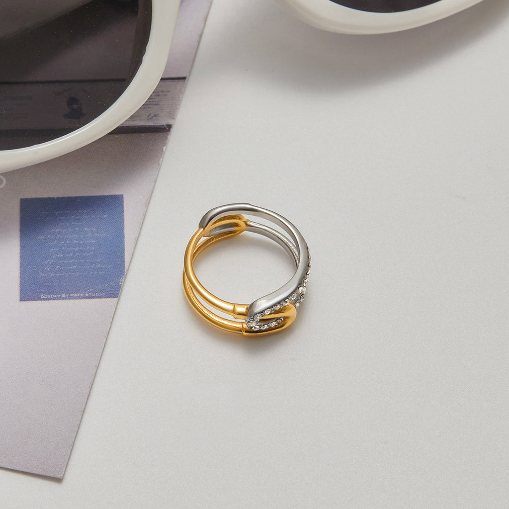 A stainless steel gold and silver color-matched rhinestone ring