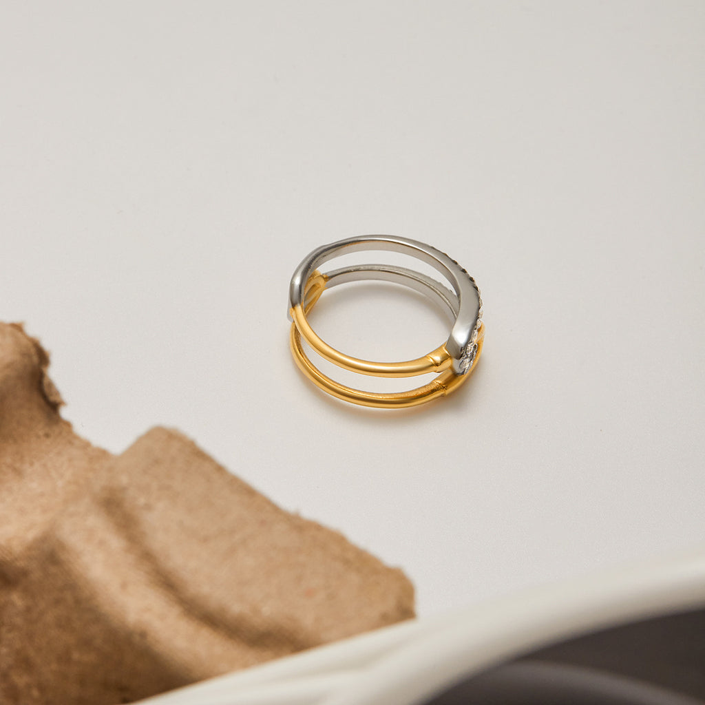 A stainless steel gold and silver color-matched rhinestone ring